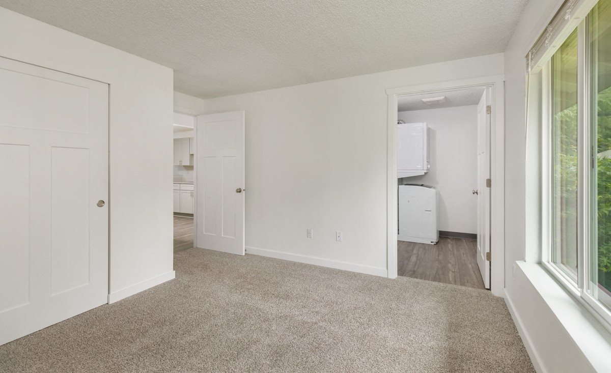 Wilderness West Apartment Interior Bedroom with Laundry Room Wilderness West Apartment Interior Bedroom with Laundry Room